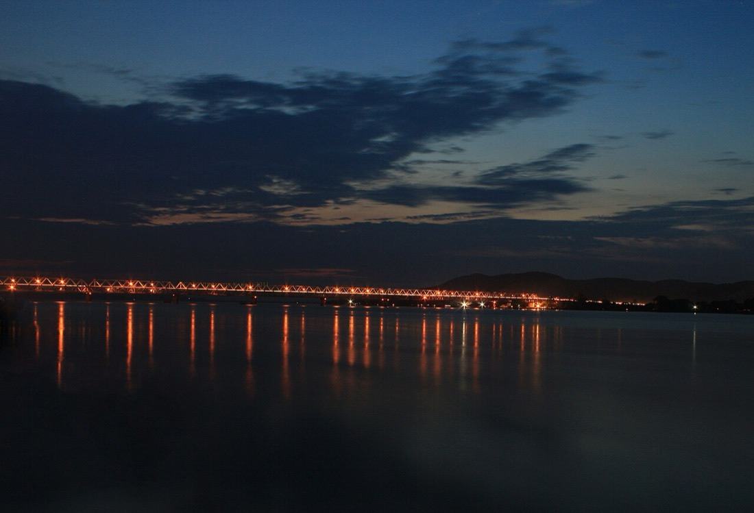Guwahati at dusk, its lights reflected in the Brahmaputra