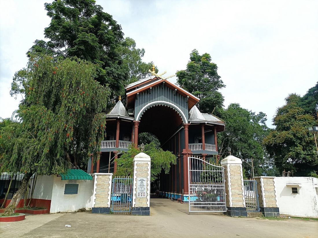 The arched royal gate of Kangla, framed by tall trees