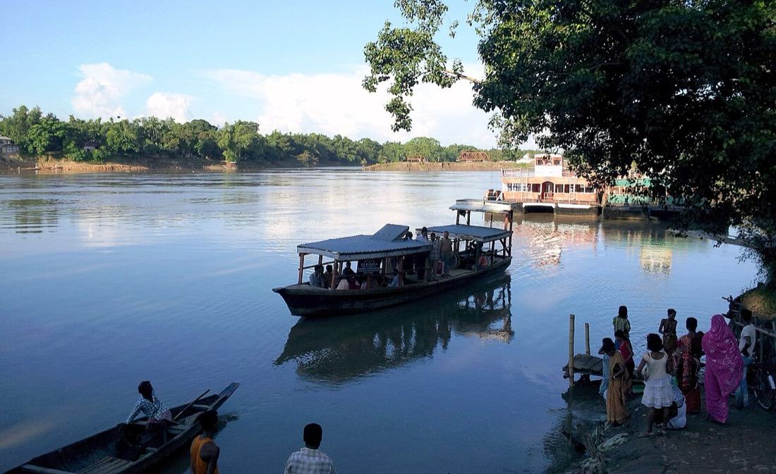 Wooden boats moored on the Barak at a ghat in Silchar
