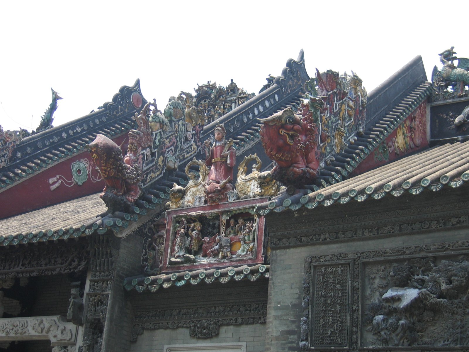 Painted figures crowding the roof ridges of the Chen Clan Ancestral Hall