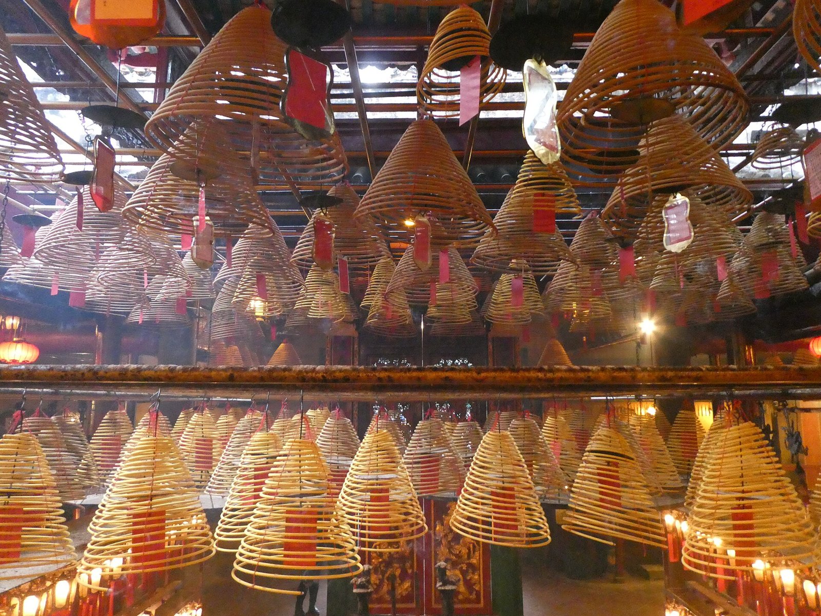 Glowing incense coils hanging inside Man Mo Temple