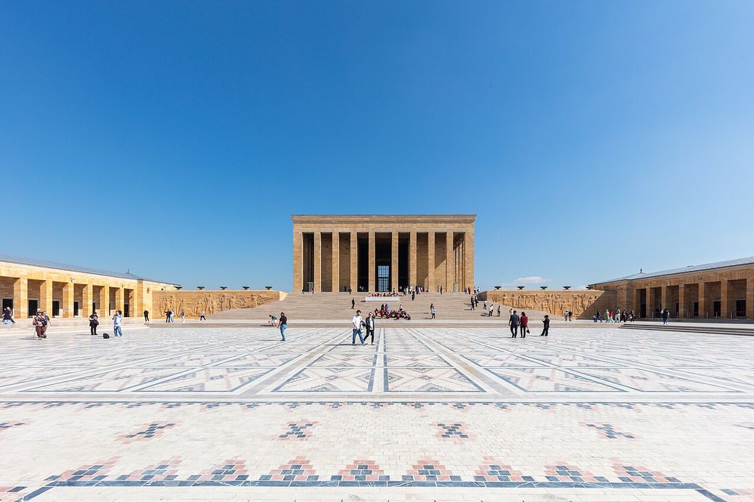 The colonnaded mausoleum of Anıtkabir at the far end of its wide, patterned ceremonial square in Ankara