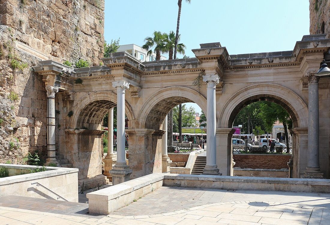 The three marble arches of Hadrian’s Gate set between stone towers in Antalya